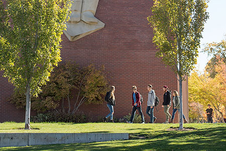 Photo of students walking in front of WSU library exterior.