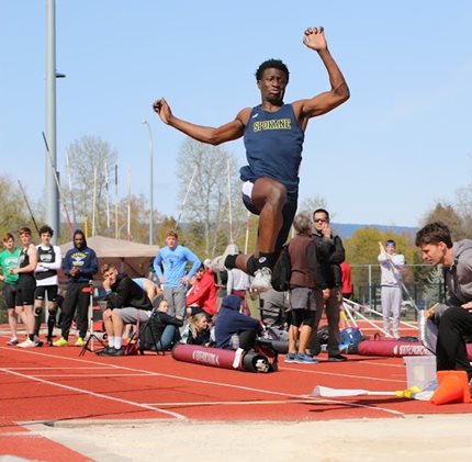 Sasquatch track and field athlete jumping into the sandpit