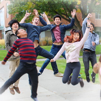 Group of students jumping with excitement