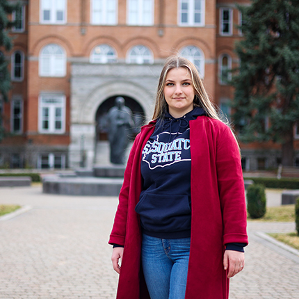 Christina Garbuz standing in front of College Hall