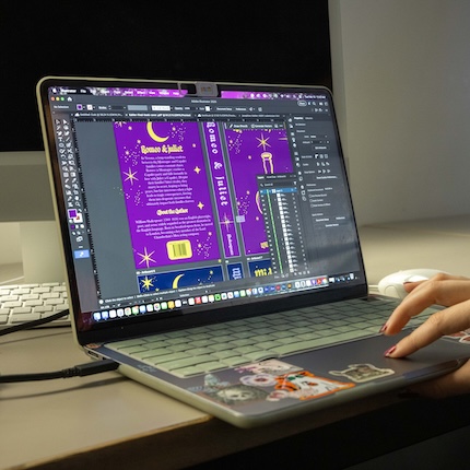 Laptop displaying an image editing application with a creative project underway