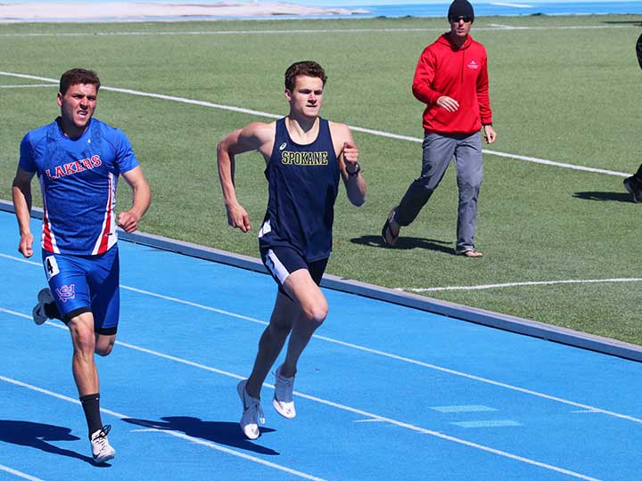 Men's track and field sprinting pas the opponent