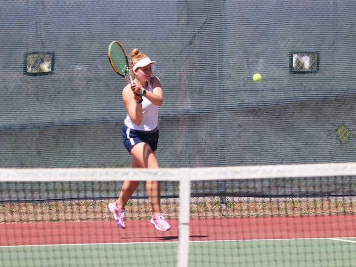 Women's tennis player preparing to return a hit